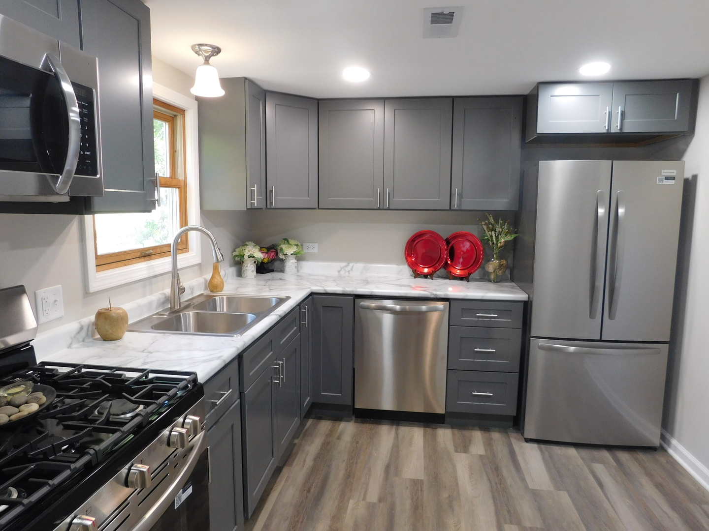 271 Toni Street Bourbonnais, IL 60914 - Photo 17 of 24 a kitchen with granite countertop stainless steel appliances a sink stove and refrigerator