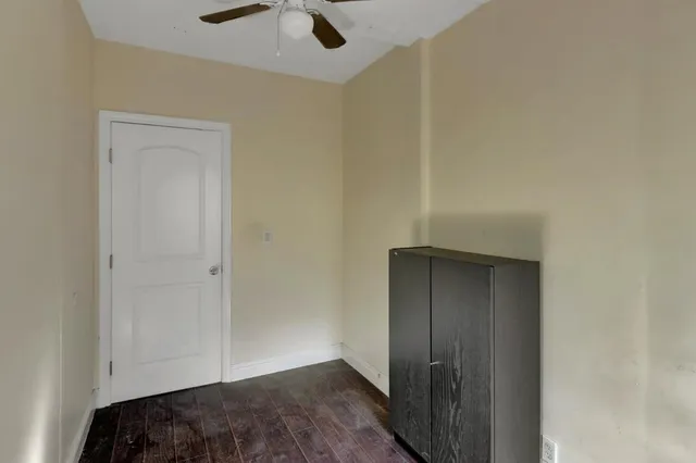 a bedroom with a bed and a painting on the wall