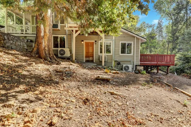a kitchen with granite countertop stainless steel appliances wooden cabinets and a stove top oven