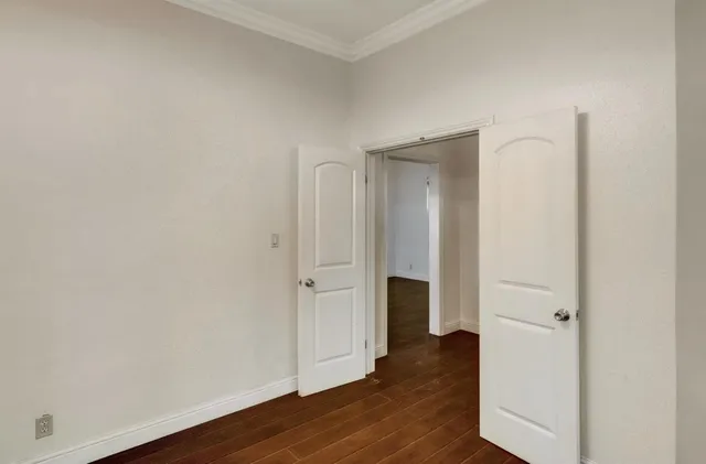 a bathroom with a granite countertop sink a mirror and shower