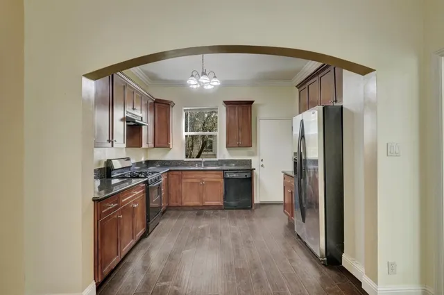 a front view of a house with a tree