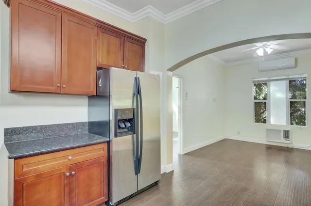 a backyard of a house with wooden deck and seating space