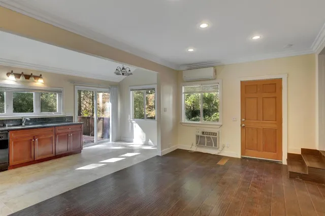 a kitchen with granite countertop a stove a sink and dishwasher wooden cabinets with granite countertops