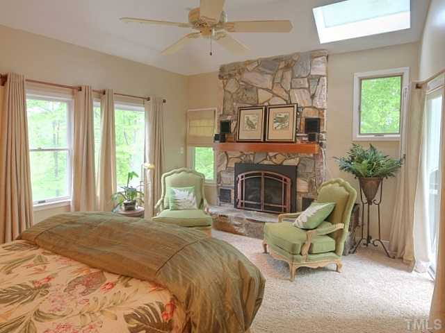 7422 Johnson Mill Road Bahama, NC 27503 - Photo 9 of 25 a bedroom with furniture fireplace and window