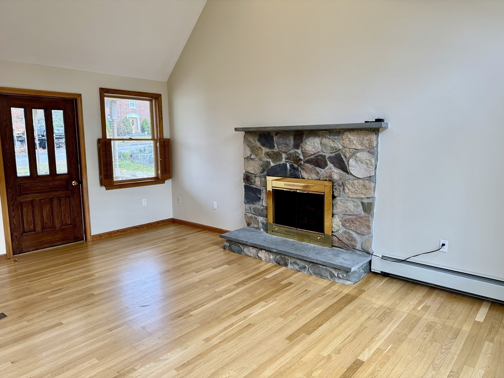 24 Cole Terrace Randolph, MA 02368 - Photo 11 of 40 a view of empty room with wooden floor and fireplace