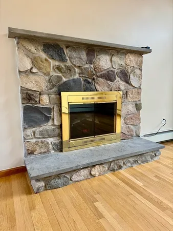 an empty room with wooden floor and a window