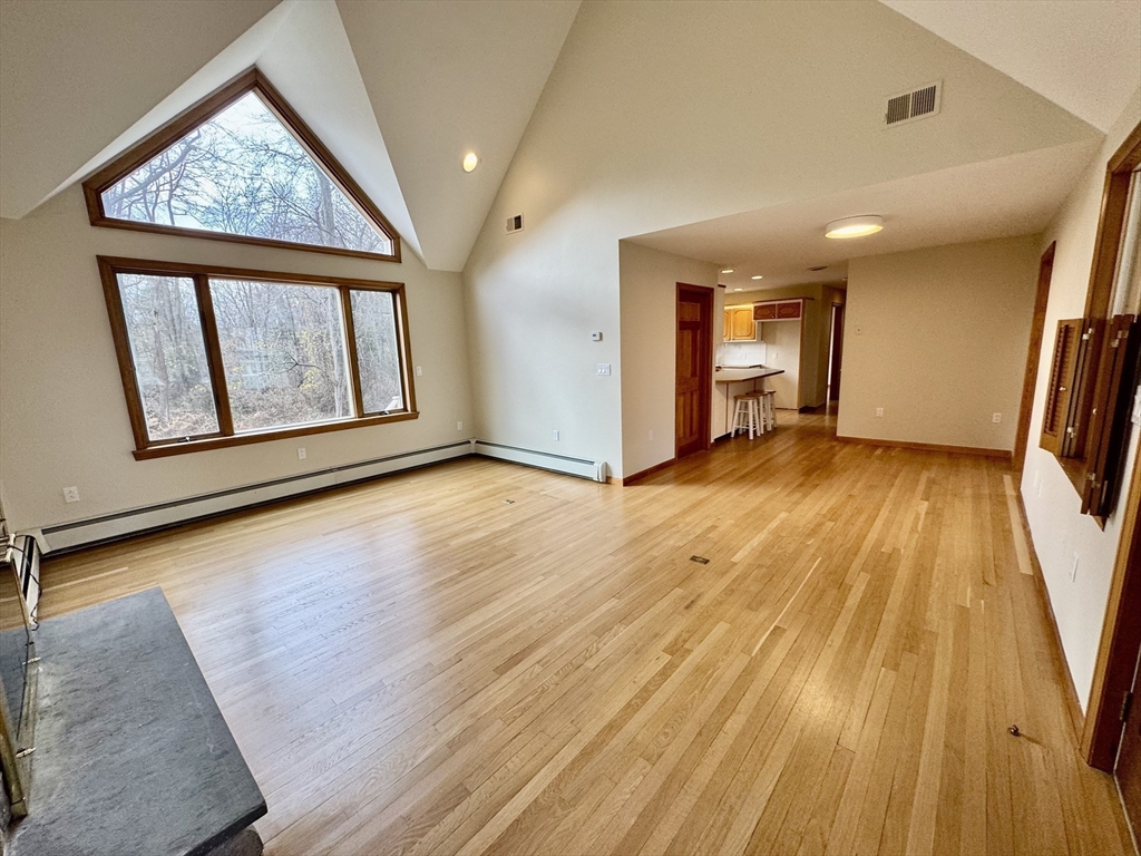 24 Cole Terrace Randolph, MA 02368 - Photo 14 of 40 an empty room with wooden floor and a window