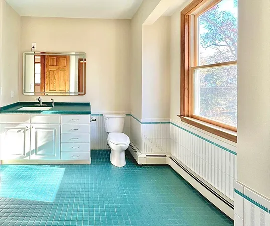 a bathroom with a tub sink and mirror