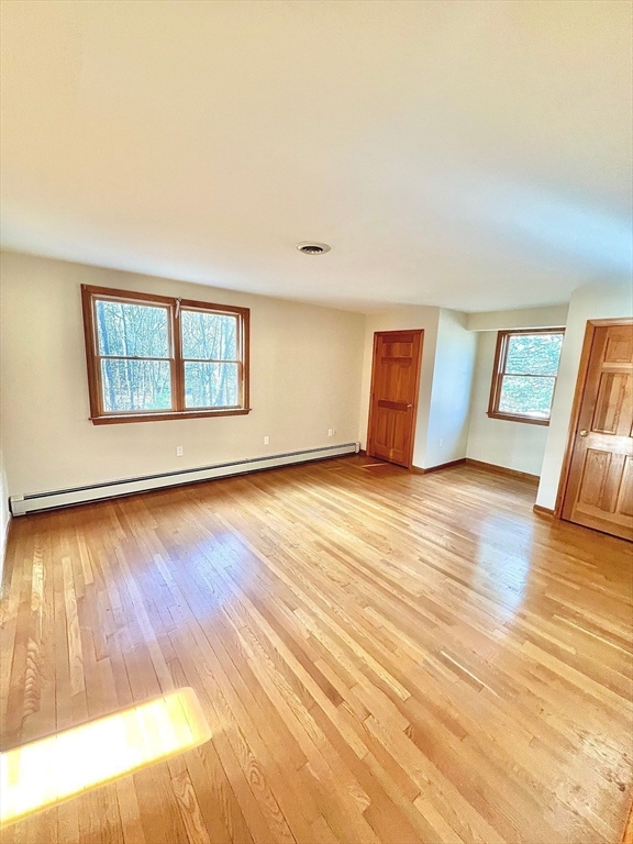 24 Cole Terrace Randolph, MA 02368 - Photo 19 of 40 a view of an empty room with wooden floor and a window