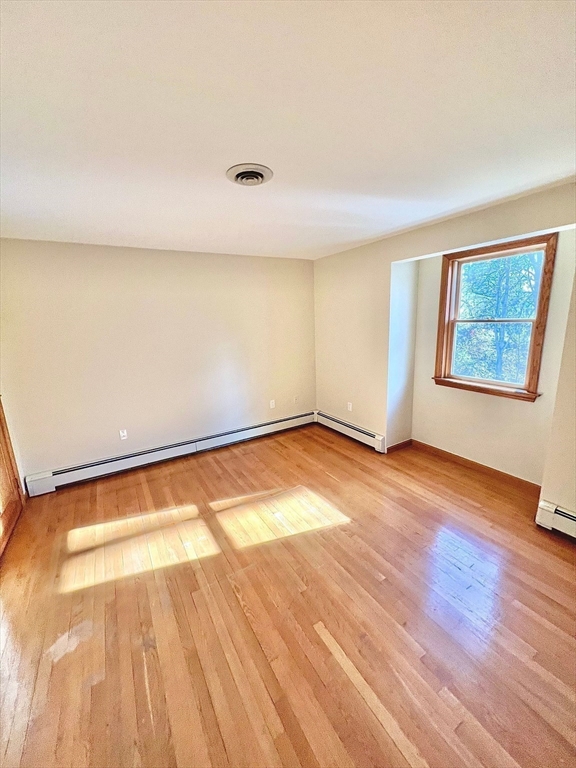 24 Cole Terrace Randolph, MA 02368 - Photo 20 of 40 a view of an empty room with wooden floor and a window