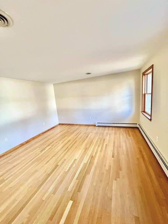24 Cole Terrace Randolph, MA 02368 - Photo 23 of 40 a view of empty room with wooden floor and fan
