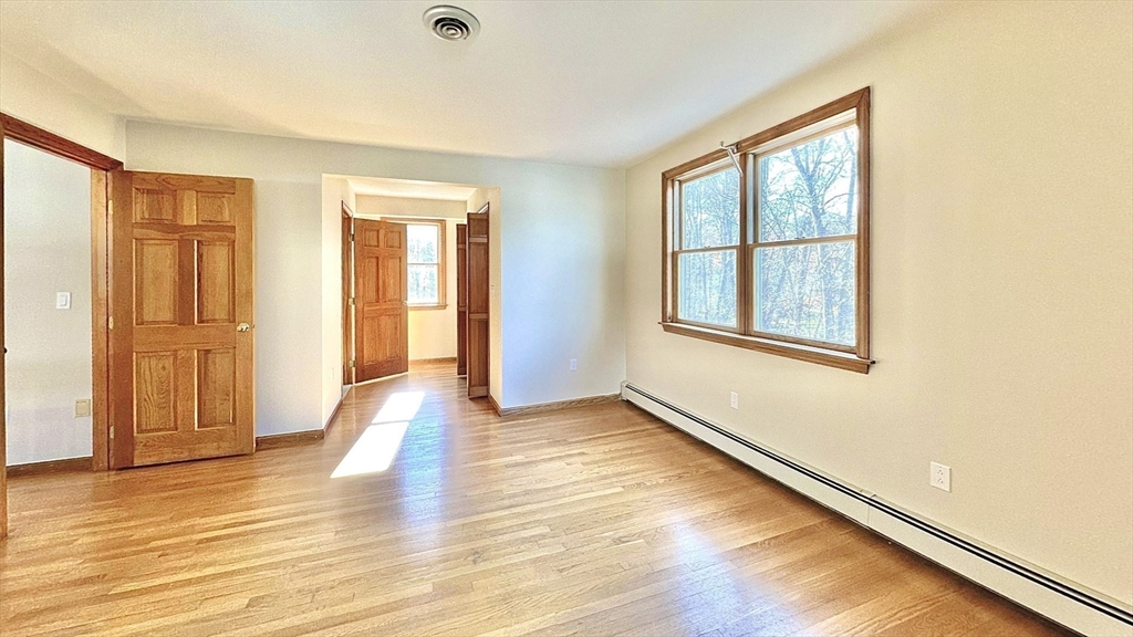 24 Cole Terrace Randolph, MA 02368 - Photo 29 of 40 a view of an empty room with wooden floor and a window