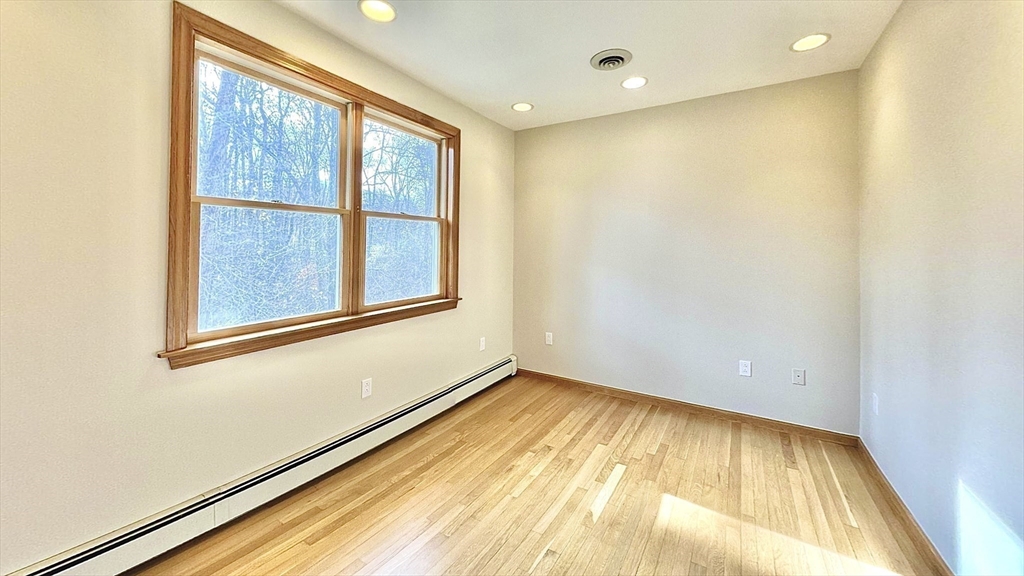 24 Cole Terrace Randolph, MA 02368 - Photo 30 of 40 a view of an empty room with wooden floor and a window