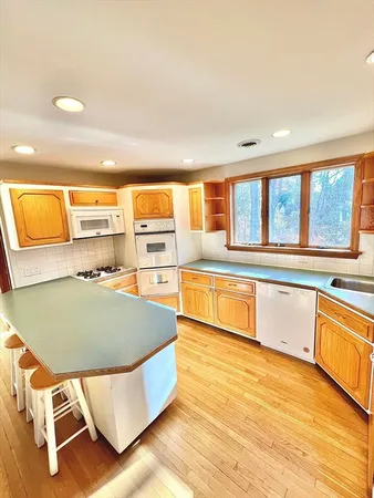 a living room with a large window and furniture