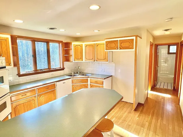 a kitchen with a sink appliances and cabinets