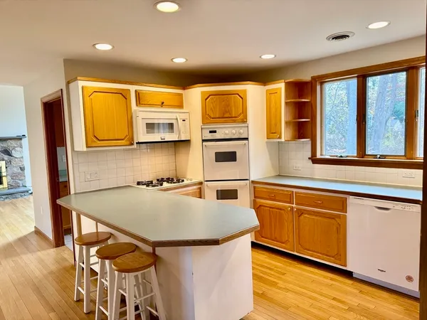an empty room with a fireplace and windows