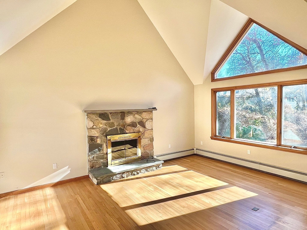 24 Cole Terrace Randolph, MA 02368 - Photo 9 of 40 an empty room with a fireplace and windows