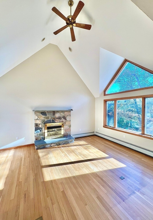 24 Cole Terrace Randolph, MA 02368 - Photo 10 of 40 an empty room with wooden floor a ceiling fan and windows