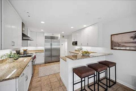 a large kitchen with a table and chairs