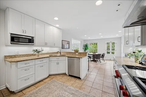 a kitchen with sink cabinets and dining table chair