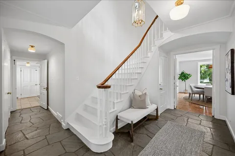 a living room with furniture and a stairs
