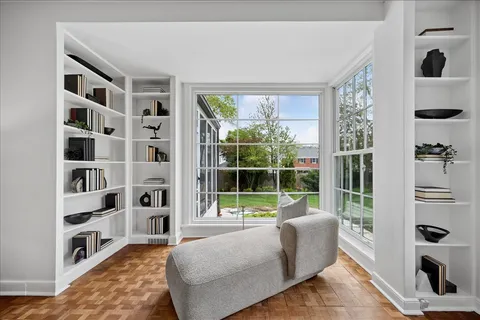 a living room with furniture cabinets and a window