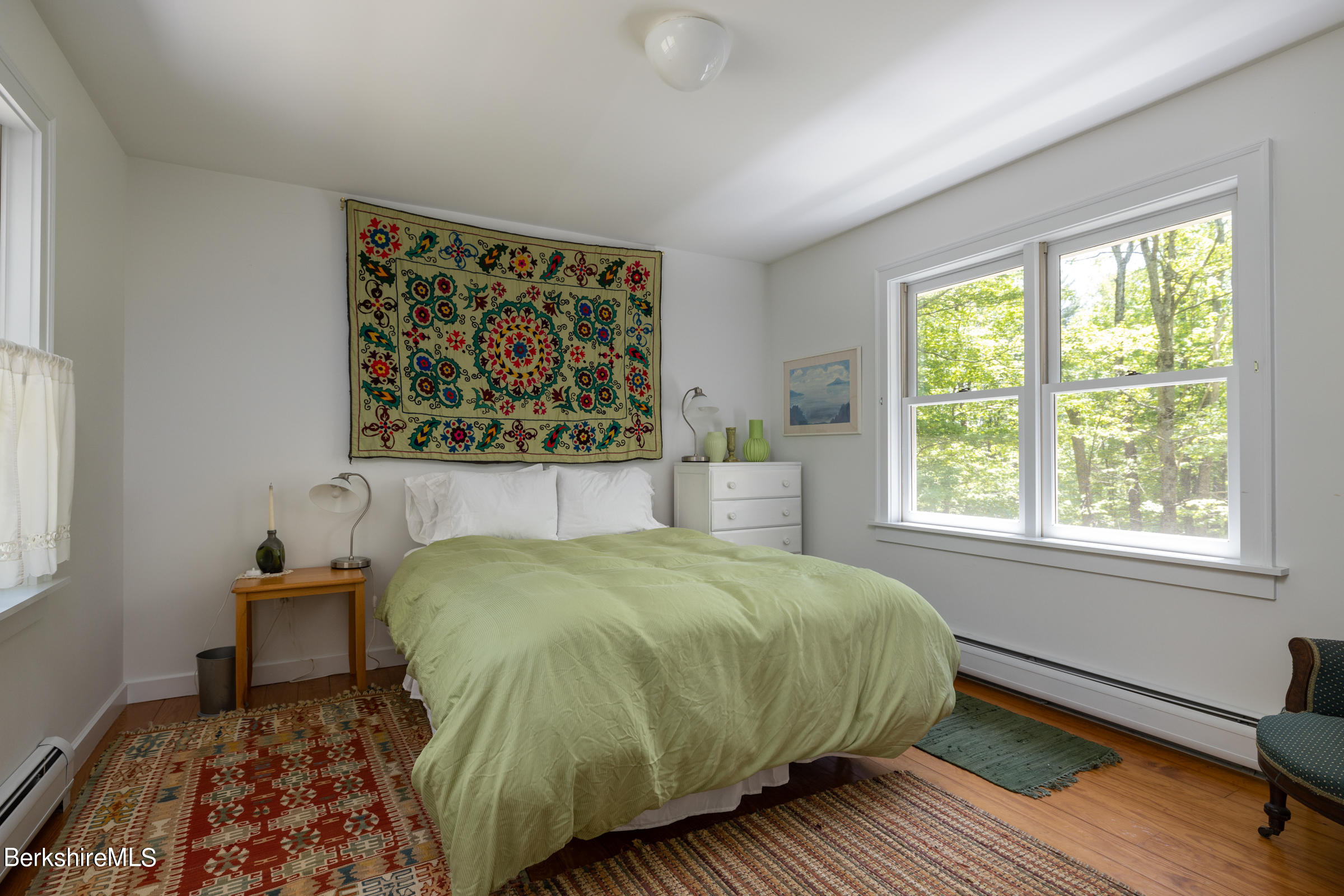 255 Hupi Road Monterey, MA 01245 - Photo 17 of 26 a bedroom with a bed and wooden floor