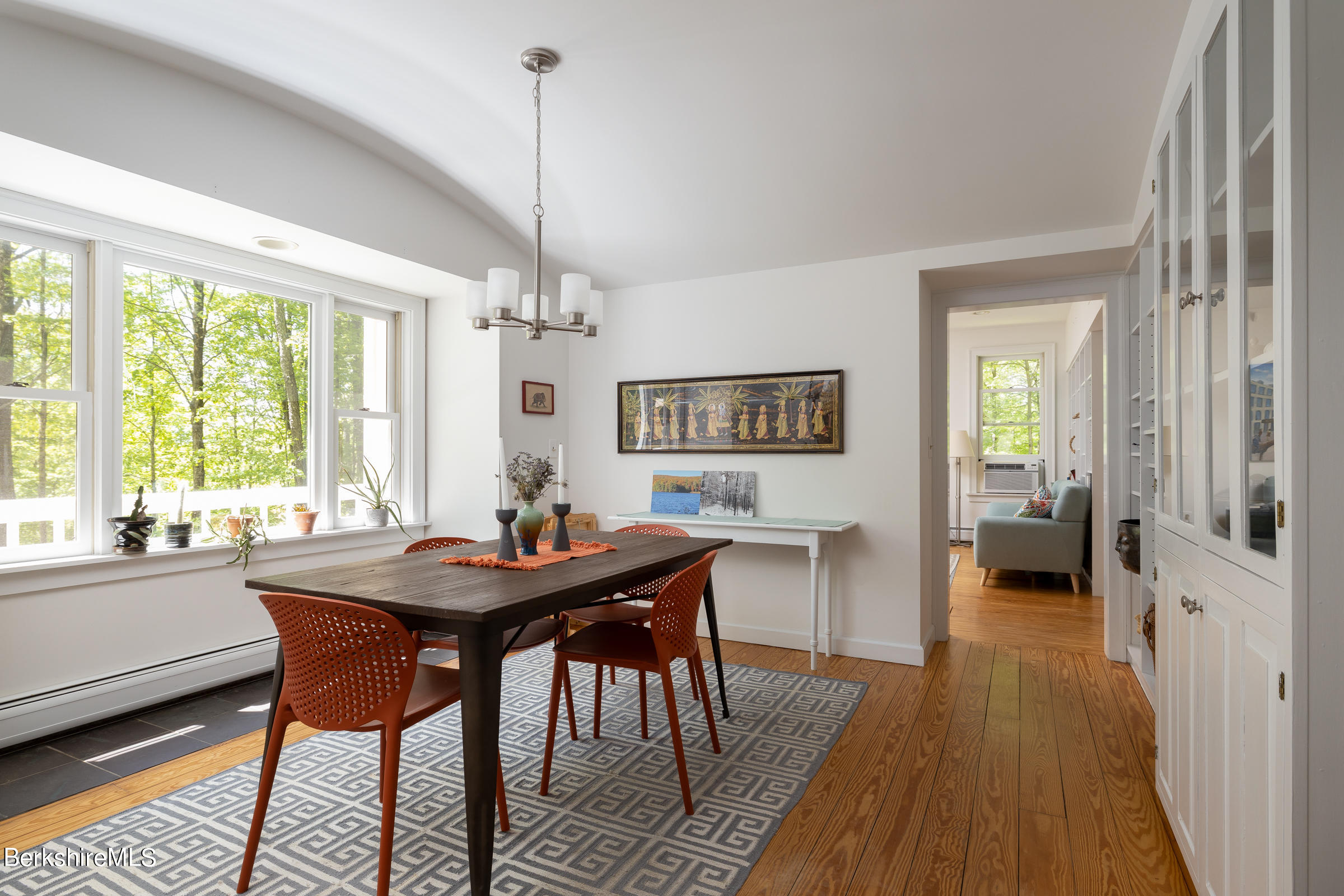 255 Hupi Road Monterey, MA 01245 - Photo 7 of 26 a dining room with furniture a chandelier and wooden floor