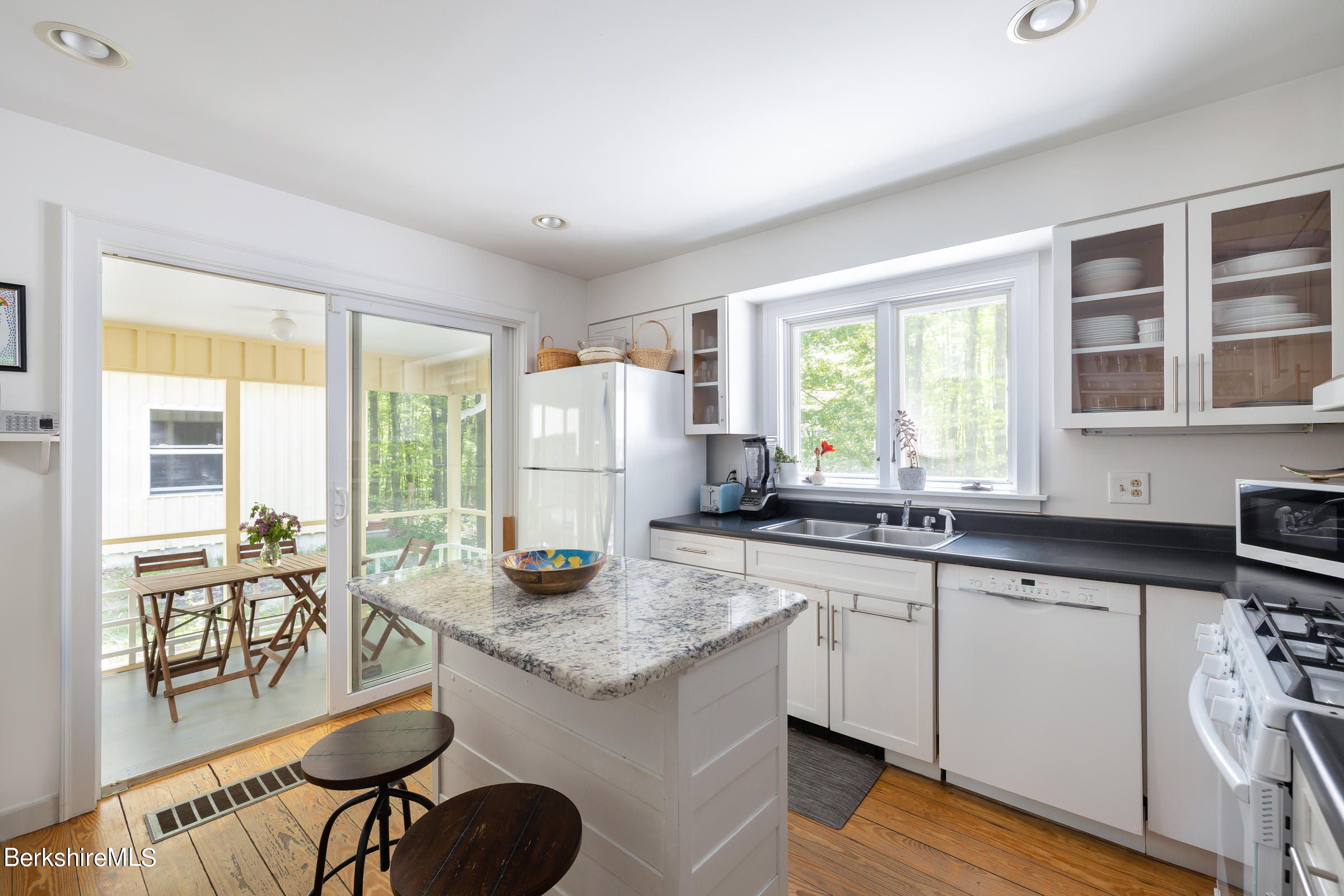 255 Hupi Road Monterey, MA 01245 - Photo 10 of 26 a kitchen with granite countertop a sink and a stove