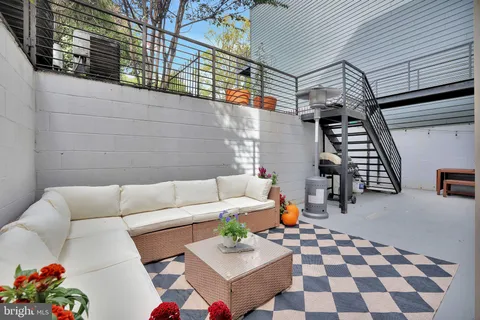a living room with furniture and a rug