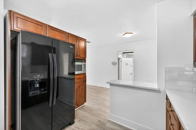 a kitchen with stainless steel appliances granite countertop a sink stove and wooden cabinets