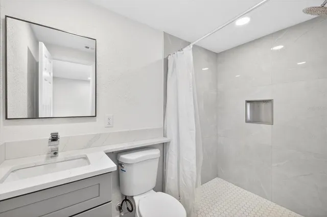 a view of an empty room with wooden floor and closet