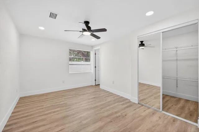 an empty room with a painting on the wall