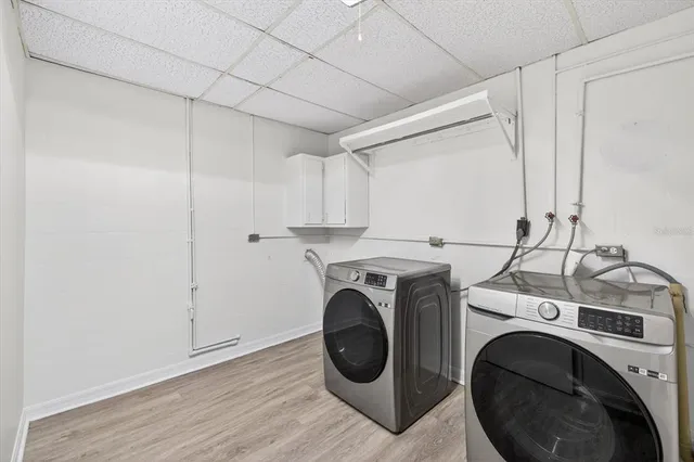 a view of an empty room with wooden floor and closet