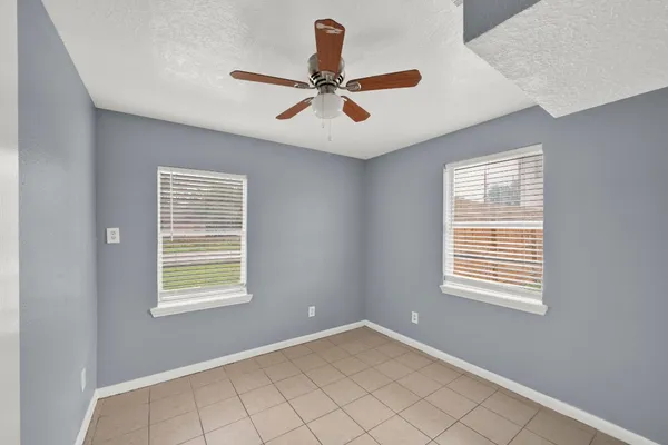a bedroom with a bed and a potted plant