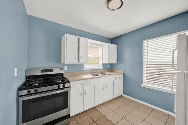 a view of kitchen with a sink dishwasher and a refrigerator