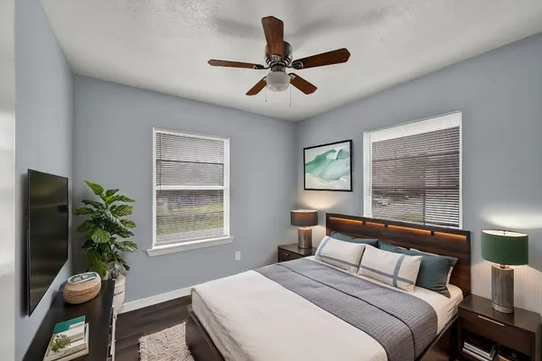 a bedroom with a large bed and a window