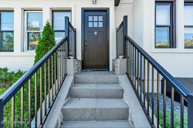 a view of staircase with lots of frames on and wooden floor