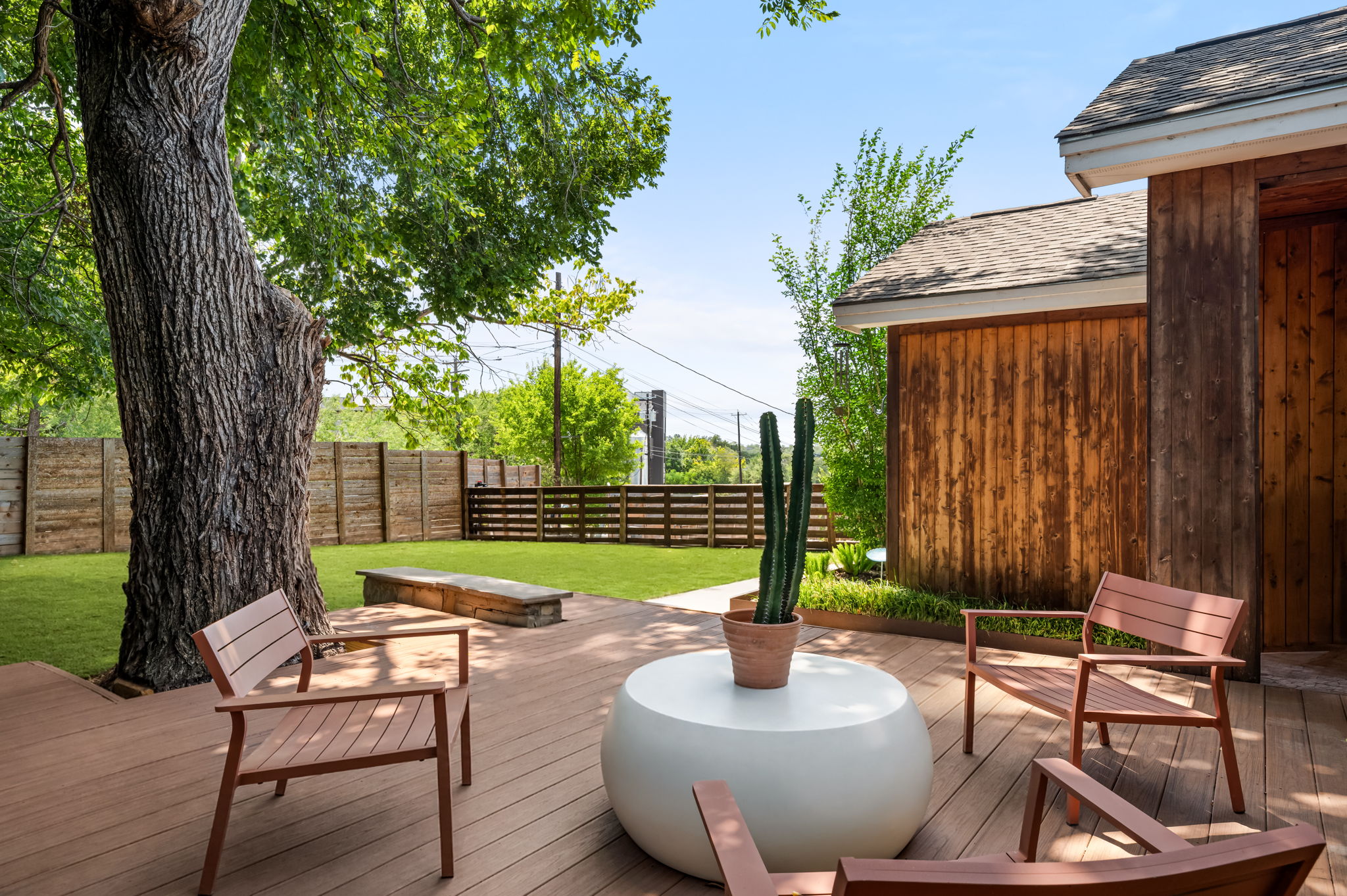 1902 Webberville Road, Unit B Austin, TX 78721 - Photo 38 of 39 An inviting backyard oasis offers a spacious wooden deck leading to a manicured lawn and private fencing.