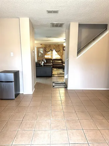 a view of a hallway to a livingroom with furniture
