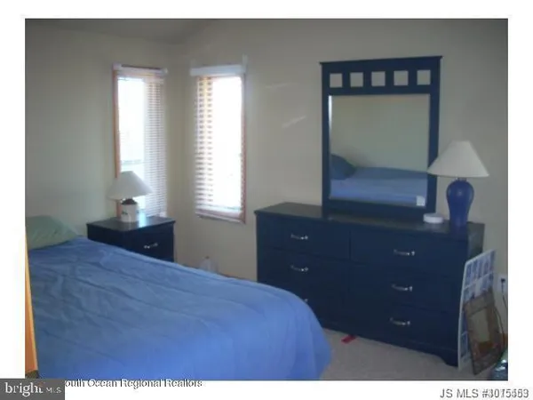 a bedroom with a bed and a mirror