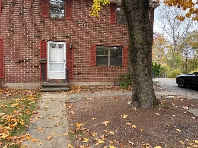 a pathway of a house with a yard