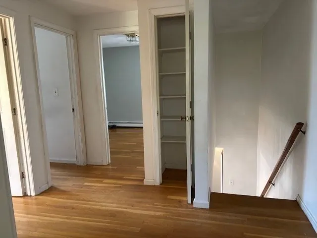 a view of a room that has a bed and a chair in it