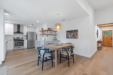 a kitchen with stainless steel appliances a sink stove refrigerator and cabinets