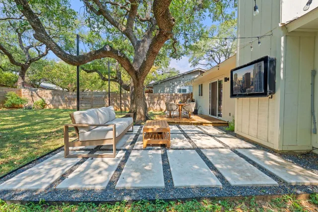 a backyard of a house with table and chairs