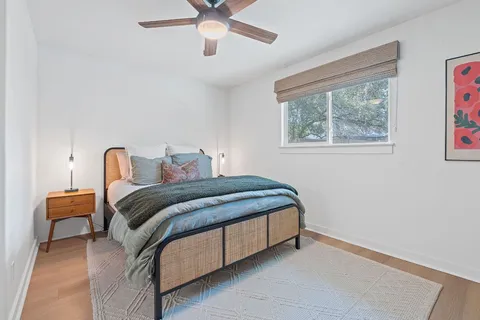 a bedroom with a bed and a ceiling fan