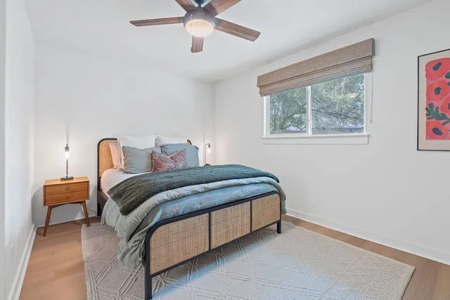 a bedroom with a bed and a ceiling fan