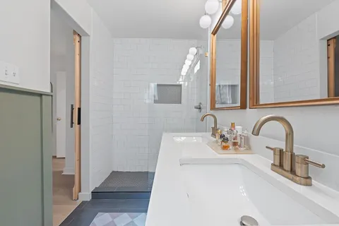 a bathroom with a toilet sink and mirror