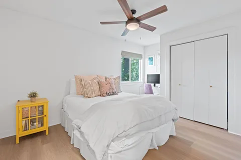 a bathroom with a sink a toilet and a large mirror