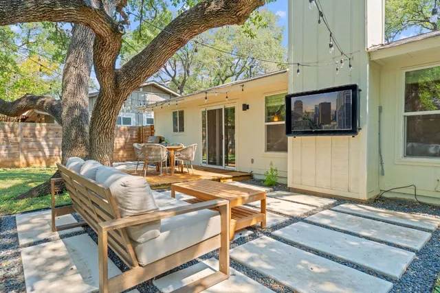a backyard of a house with table and chairs